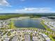 From an aerial view, appreciate the large lake surrounded by homes, apartments, and trees within a structured community layout at 4704 Sleepy Hollow Dr, Kissimmee, FL 34746