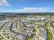 Expansive aerial view of a Primary-planned community with homes, lakes, and resort-style amenities on a sunny day at 4704 Sleepy Hollow Dr, Kissimmee, FL 34746