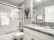 Bathroom featuring shower/tub combo with sliding glass doors, granite countertop, and neutral wall color at 4704 Sleepy Hollow Dr, Kissimmee, FL 34746