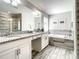 Elegant bathroom with dual vanities, granite countertops, soaking tub, and tiled shower, creating a spa-like retreat at 4704 Sleepy Hollow Dr, Kissimmee, FL 34746