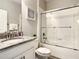 Clean bathroom with a granite countertop vanity, a shower-tub combo, and white tile at 4704 Sleepy Hollow Dr, Kissimmee, FL 34746
