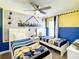 Playful ' bedroom with twin beds, Minion-themed decor, and a large mural creating a whimsical atmosphere at 4704 Sleepy Hollow Dr, Kissimmee, FL 34746