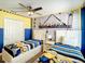 Whimsical ' bedroom featuring twin beds, playful decor, and a ceiling fan for added comfort at 4704 Sleepy Hollow Dr, Kissimmee, FL 34746