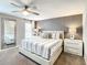 Relaxing bedroom featuring a comfortable bed, designer lamps, and ample natural light at 4704 Sleepy Hollow Dr, Kissimmee, FL 34746