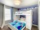 A bedroom featuring 'Frozen' themed decor, a bunk bed, and a window with curtains at 4704 Sleepy Hollow Dr, Kissimmee, FL 34746