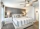 Cozy bedroom showcasing a patterned accent wall, a comfortable bed, and stylish bedside tables at 4704 Sleepy Hollow Dr, Kissimmee, FL 34746