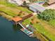 Private dock featuring a covered gazebo, boat lift, and kayaks, with easy access to the lake at 4704 Sleepy Hollow Dr, Kissimmee, FL 34746