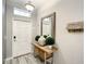 Inviting entryway featuring tiled floors, a decorative table, and welcome decor at 4704 Sleepy Hollow Dr, Kissimmee, FL 34746
