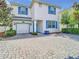 Charming two-story home with blue shutters and a brick driveway at 4704 Sleepy Hollow Dr, Kissimmee, FL 34746