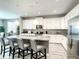 Modern kitchen with an island, gray counters, and stainless steel appliances at 4704 Sleepy Hollow Dr, Kissimmee, FL 34746