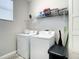 Laundry room featuring washer, dryer, wire rack, and neutral wall color at 4704 Sleepy Hollow Dr, Kissimmee, FL 34746