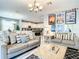 Open-concept living room flows into a modern kitchen with a large island and stainless steel appliances at 4704 Sleepy Hollow Dr, Kissimmee, FL 34746