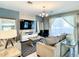 Stylish living room featuring comfortable sofas, a modern entertainment center, and large windows for natural light at 4704 Sleepy Hollow Dr, Kissimmee, FL 34746