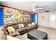 Inviting living room featuring comic book decor, a large sectional sofa, and a ceiling fan at 4704 Sleepy Hollow Dr, Kissimmee, FL 34746