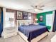 A well-lit main bedroom featuring contemporary decor, a ceiling fan, and neutral carpeting at 4704 Sleepy Hollow Dr, Kissimmee, FL 34746