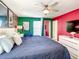 A well-lit main bedroom featuring contemporary decor, a ceiling fan, and neutral carpeting at 4704 Sleepy Hollow Dr, Kissimmee, FL 34746