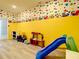 This playroom has fun cartoon wallpaper, light gray floors and kid friendly toys at 4704 Sleepy Hollow Dr, Kissimmee, FL 34746