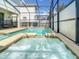 Enjoy the in-ground jacuzzi, part of the property's screened-in pool and lanai at 4704 Sleepy Hollow Dr, Kissimmee, FL 34746