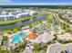 Aerial view of resort-style water park with pools, lazy river, and play areas surrounded by lush landscaping at 4704 Sleepy Hollow Dr, Kissimmee, FL 34746
