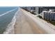 Aerial view of the beachside, condos, and Atlantic Ocean at 5201 S Atlantic Ave # 405A, New Smyrna Beach, FL 32169