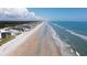 Aerial view of a beachside community, showcasing the expansive beach and ocean views at 5201 S Atlantic Ave # 405A, New Smyrna Beach, FL 32169