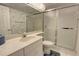 Bathroom featuring a vanity with a white countertop, a toilet, and a glass-enclosed shower at 5201 S Atlantic Ave # 405A, New Smyrna Beach, FL 32169