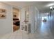 Hallway featuring tile flooring, a decorative cabinet, and a partial view of the bedroom at 5201 S Atlantic Ave # 405A, New Smyrna Beach, FL 32169