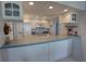 Cozy kitchen features white cabinets, tile backsplash, and modern appliances at 5201 S Atlantic Ave # 405A, New Smyrna Beach, FL 32169