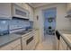 Efficient kitchen featuring white appliances, ample cabinet space, and tile countertops at 5201 S Atlantic Ave # 405A, New Smyrna Beach, FL 32169