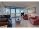 Living area with ocean views, comfortable furnishings and access to balcony at 5201 S Atlantic Ave # 405A, New Smyrna Beach, FL 32169