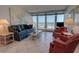 Cozy living area with ocean views, comfortable seating, and a relaxed atmosphere at 5201 S Atlantic Ave # 405A, New Smyrna Beach, FL 32169