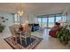 Bright living room with ocean view, comfortable seating and dining area at 5201 S Atlantic Ave # 405A, New Smyrna Beach, FL 32169