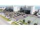 Aerial view of a parking lot, tennis court, and complex at 5201 S Atlantic Ave # 405A, New Smyrna Beach, FL 32169