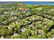 Areal neighborhood view featuring homes with waterfront access, a lake, and lush green surroundings at 5370 Whispering Pine Cir, St Cloud, FL 34771