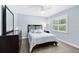 Relaxing blue bedroom with a window, soft carpet, dark wood furniture, and comfortable bed at 5370 Whispering Pine Cir, St Cloud, FL 34771