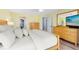 This bedroom features wood laminate flooring, a ceiling fan and direct access to the main bath at 5370 Whispering Pine Cir, St Cloud, FL 34771