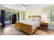 Bright bedroom featuring a light wood bed frame, private access to the outdoor pool area, and natural light at 5370 Whispering Pine Cir, St Cloud, FL 34771
