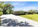 Well-manicured home exterior with a long driveway and attached garage at 5370 Whispering Pine Cir, St Cloud, FL 34771