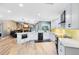 Modern kitchen with white cabinets, breakfast bar, and stainless steel appliances at 5370 Whispering Pine Cir, St Cloud, FL 34771