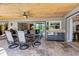 Covered patio with a dining table set, wet bar, tile flooring, and view into the home at 5370 Whispering Pine Cir, St Cloud, FL 34771
