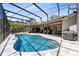 A clear blue pool under a screened enclosure, surrounded by seating and a barrel sauna at 5370 Whispering Pine Cir, St Cloud, FL 34771