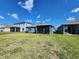 Spacious backyard with green grass and view of neighboring houses at 5526 Bonn Way, St Cloud, FL 34771