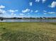 Pond view from the backyard with houses visible in the distance at 5526 Bonn Way, St Cloud, FL 34771