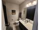 Well-maintained bathroom featuring vanity with sink, toilet, and framed mirror at 5526 Bonn Way, St Cloud, FL 34771