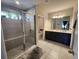 A modern bathroom features a tile shower, double vanity, and ample natural light at 5526 Bonn Way, St Cloud, FL 34771