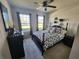 Well-lit bedroom with comfortable bed, black furniture, and decorative accents at 5526 Bonn Way, St Cloud, FL 34771