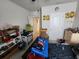 This bedroom features a ceiling fan, a bed and shelving for storage, though it appears to need tidying and organization at 5526 Bonn Way, St Cloud, FL 34771