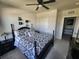 Comfortable bedroom with ceiling fan, plush carpeting, and dark furniture at 5526 Bonn Way, St Cloud, FL 34771