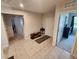 Inviting foyer with neutral tile flooring, console table, and clear view to other rooms at 5526 Bonn Way, St Cloud, FL 34771