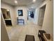 Neutral foyer with tile flooring showing access to bathroom, hallway, and living area at 5526 Bonn Way, St Cloud, FL 34771